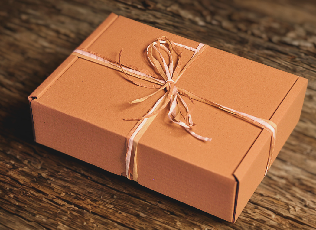 eco freindly sealed gift box with hand tied raffia ribbon.